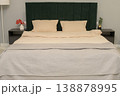 Modern bedroom interior with green upholstered headboard and neutral bedding 138878995