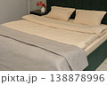 Modern bedroom with neatly made bed and decorative pillows on display 138878996