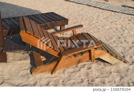 Wooden chaise lounge on the beach Wooden chaise lounge on the beach 138879104