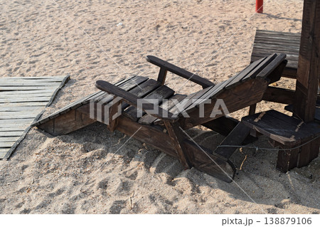 Wooden chaise lounge on the beach Wooden chaise lounge on the beach 138879106