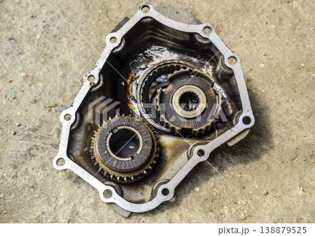 Dismantled box car transmissions. Gear with bearings and gearbox housing. The gears on the shaft of a mechanical transmission. Dismantled box car transmissions. Gear with bearings and gearbox housing. The gears on the shaft of a mechanical transmission. 138879525