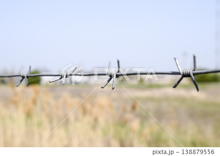Barbed wire. Barbed wire fencing. The constraint symbol. 138879556