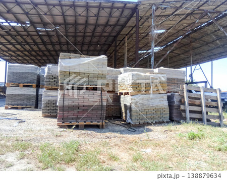 Tiles piled in pallets. Warehouse paving slabs in the factory for its production. Tiles piled in pallets. Warehouse paving slabs in the factory for its production. 138879634