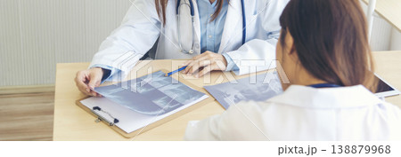 Banner hands of two women doctor medical lab discussing together healthcare teamwork. Panorama Two asian women doctors meeting write prescription medical clinic office using laptop with copy space. 138879968