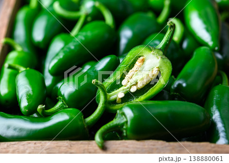 Jalapeno peppers pile with one cut piece placed on top Jalapeno peppers pile with one cut piece placed on top 138880061