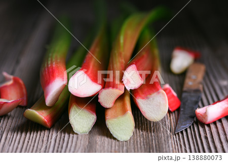 Rhubarb stalk ends arranged diagonally on wooden surface Rhubarb stalk ends arranged diagonally on wooden surface 138880073