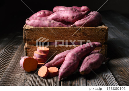 Sweet potato with sliced rounds in wooden box. Sweet potato with sliced rounds in wooden box. 138880101