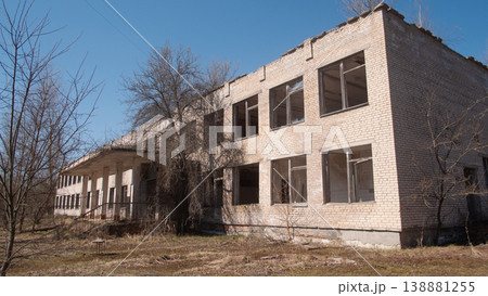 Deserted School Facade With Broken Windows, Peeling Plaster And Empty Classrooms Visible Through Glass, 138881255