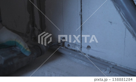 Securing Cable Channel With Gloves. Worker Uses Gloves While Installing Conduit Safely. Closeup Of Technician Wearing Gloves While Securing And Installing Electrical Conduit Safely Securing Cable Channel With Gloves. Worker Uses Gloves While Installing Conduit Safely. Closeup Of Technician Wearing Gloves While Securing And Installing Electrical Conduit Safely 138881284