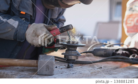 Repair Technician Cutting Metal With Grinder, Sparks And Debris Showering Work Surface, Hands Steadying Part, Urgent Maintenance Scene On Outdoor Bench With Utilitarian Tools And Protective Repair Technician Cutting Metal With Grinder, Sparks And Debris Showering Work Surface, Hands Steadying Part, Urgent Maintenance Scene On Outdoor Bench With Utilitarian Tools And Protective 138881285