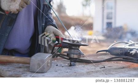 Artisan Shaping Steel With Grinder, Focused Hands Smoothing Edge And Producing Controlled Sparks, Finishing Work On Bench With Skilled Technique, Textured Metal Surface And Professional Artisan Shaping Steel With Grinder, Focused Hands Smoothing Edge And Producing Controlled Sparks, Finishing Work On Bench With Skilled Technique, Textured Metal Surface And Professional 138881287