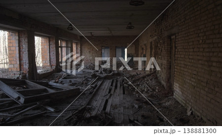 Gutted Storage Hall With Collapsed Wooden Flooring, Scattered Planks And Low Light Scene Reads As Structural Survey Site For Engineer Assessing Post Conflict Damage And Potential 138881300