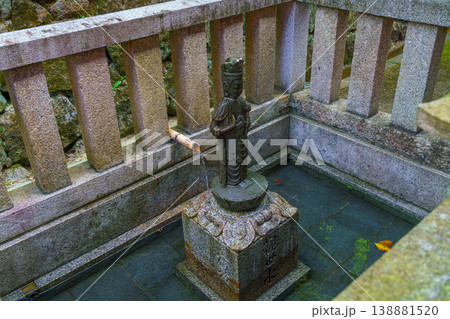 Kyoto, Japan - Oct 11 2025, Close-up view of a small bronze sculpture of a saint plased in a small stone pool, on the territory of Kiyomizu-dera Temple, without people, Kyoto, Japan Kyoto, Japan - Oct 11 2025, Close-up view of a small bronze sculpture of a saint plased in a small stone pool, on the territory of Kiyomizu-dera Temple, without people, Kyoto, Japan 138881520