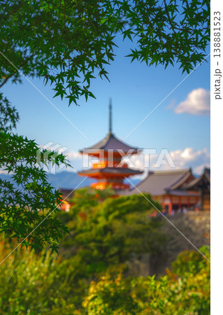 Kyoto, Japan - Oct 11 2024, vertical view through foliage of Kiyomizu-Dera temple complex with a pagoda, with a clear blue sky and a forest in foreground, at daytime, blurred, Kyoto, Japan 138881523
