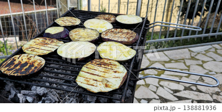 Close up view of Roasted eggplants on carbon barbecue Close up view of Roasted eggplants on carbon barbecue 138881936