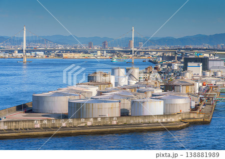Osaka, Japan - Oct 11 2024, panoramic view from the water of oil storage tanks in the foreground, Konohana Bridge and cityscape of Osaka in the background, at daytime, Osaka, Japan Osaka, Japan - Oct 11 2024, panoramic view from the water of oil storage tanks in the foreground, Konohana Bridge and cityscape of Osaka in the background, at daytime, Osaka, Japan 138881989