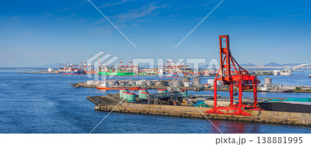 Osaka, Japan - Oct 11 2024, Panoramic view of the commercial port of Osaka with cranes and containers, with the Evergreen cargo ship moored in the background, at daytime, Osaka, Japan Osaka, Japan - Oct 11 2024, Panoramic view of the commercial port of Osaka with cranes and containers, with the Evergreen cargo ship moored in the background, at daytime, Osaka, Japan 138881995