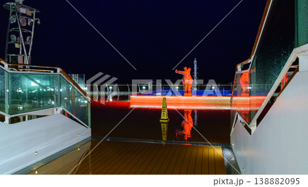 Muroran, Hokkaido, Japan - Oct 04 2024, panoramic view of pool decorated with a sculpture of a plump woman in a swimsuit, on upper deck of the MSC Bellissima cruise ship, at night, Muroran, Japan 138882095