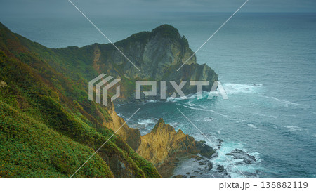 Muroran, Hokkaido, Japan - Oct 04 2024, panoramic aerial view of the picturesque Pacific ocean coast with sharp cliffs and high mountain slopes, in a storm, it's raining, at daytime, Muroran, Japan Muroran, Hokkaido, Japan - Oct 04 2024, panoramic aerial view of the picturesque Pacific ocean coast with sharp cliffs and high mountain slopes, in a storm, it's raining, at daytime, Muroran, Japan 138882119