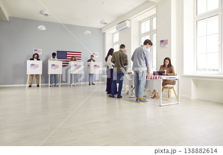 Diverse group of people registering at polling station standing in a queue at vote center Diverse group of people registering at polling station standing in a queue at vote center 138882614