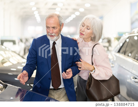 Elderly couple chooses new car together at car dealership 138884715