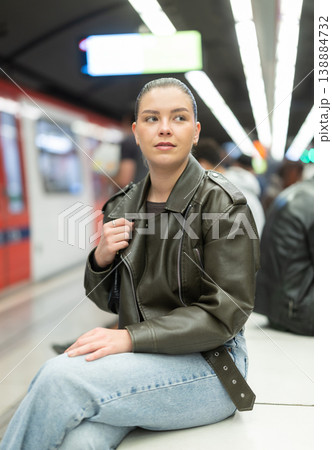Young woman sitting at subway station 138884732