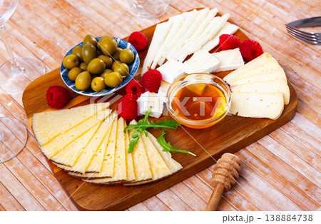 Cheese plate with raspberry and olives Cheese plate with raspberry and olives 138884738