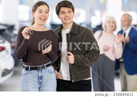 Elderly couple giving car keys to mature couple at dealership 138884811