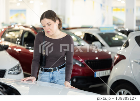 woman choosing a car in a car dealership woman choosing a car in a car dealership 138885127
