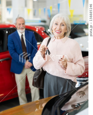 Elderly couple chooses new car together at car dealership Elderly couple chooses new car together at car dealership 138885146