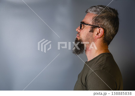 Profile of man with glasses in a studio setting Profile of man with glasses in a studio setting 138885838