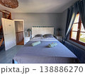 A Cozy Bedroom Interior that Features Modern Decor and Abundant Natural Light Throughout the Space 138886270