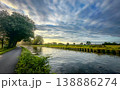 Explore a stunning river landscape with lush greenery and dramatic clouds for great adventure 138886274