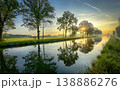 A colorful sunrise reflection over a tranquil canal captivates viewers with beauty and harmony 138886276
