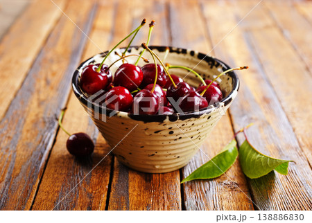 Fresh sweet cherries bowl on wooden background, top view. Space for text 138886830