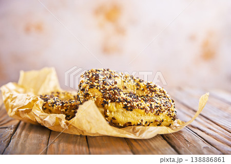 Overhead view of freshly baked bagels a table, top view of homemade bagels on paper Overhead view of freshly baked bagels a table, top view of homemade bagels on paper 138886861