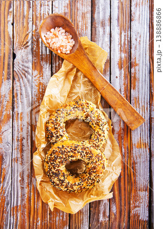 Overhead view of freshly baked bagels a table, top view of homemade bagels on paper 138886866