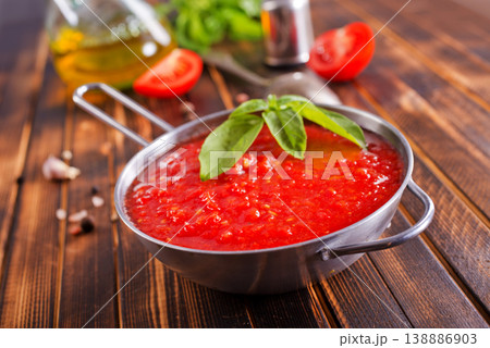 Tomato soup or gazpacho with ingredients on wooden table. Tomato soup or gazpacho with ingredients on wooden table. 138886903