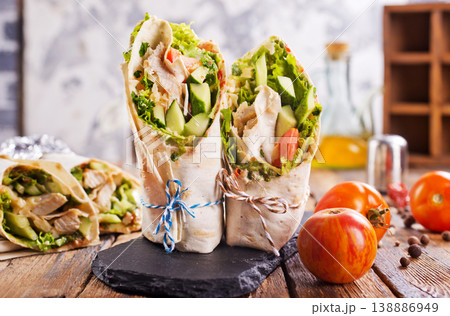Tortilla wraps with chicken fillet and vegetables. Tortilla wraps with chicken fillet and vegetables. 138886949