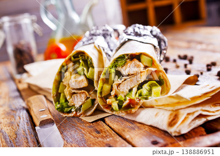 Tortilla wraps with chicken fillet and vegetables. Tortilla wraps with chicken fillet and vegetables. 138886951