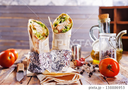 Tortilla wraps with chicken fillet and vegetables. Tortilla wraps with chicken fillet and vegetables. 138886953