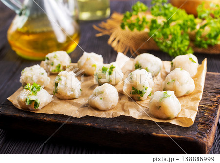 raw chicken balls on wooden board 138886999