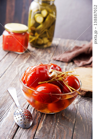 Assortie Jars of Marinated vegetables picles tomato on a wooden background Assortie Jars of Marinated vegetables picles tomato on a wooden background 138887012