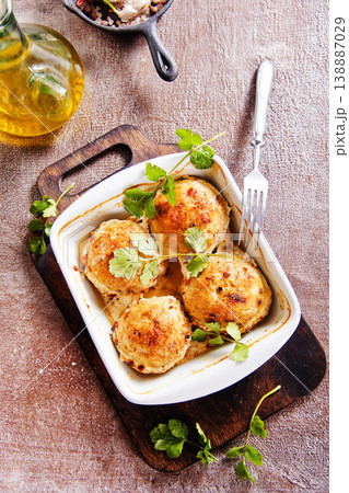 baked chicken cutlets in white bowl 138887029