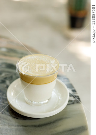 Cup of milk latte coffee on table by the street. Cup of milk latte coffee on table by the street. 138887581