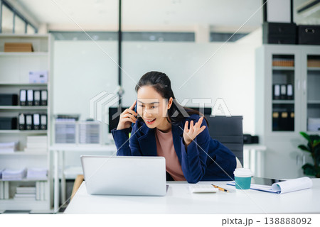 sian businesswoman using tablet to analyze tax and finance reports at modern office desk with laptop and charts, showcasing digital accounting and success. 138888092