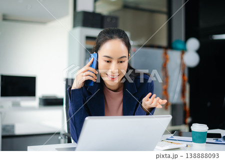 sian businesswoman using tablet to analyze tax and finance reports at modern office desk with laptop and charts, showcasing digital accounting and success. sian businesswoman using tablet to analyze tax and finance reports at modern office desk with laptop and charts, showcasing digital accounting and success. 138888093