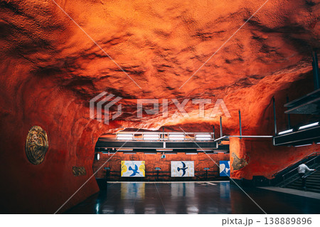 Orange rock cave tunnel with golden ornament at Ostermalmstorg metro station 138889896