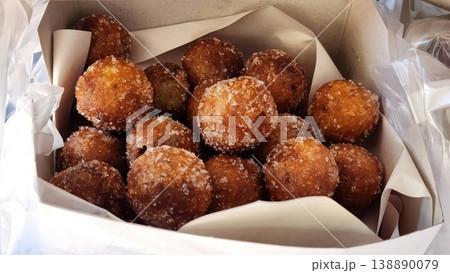 Delicious Golden Fried Sweet Potato Balls Coated in Sugar in a Takeaway Box 138890079