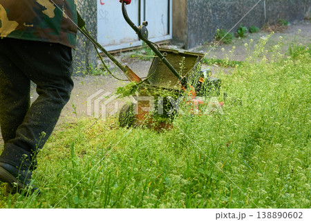 Handle lawn mower,grass cutting on green meadow Handle lawn mower,grass cutting on green meadow 138890602